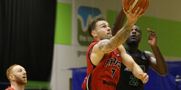 Canterbury Rams player Jeremy Kendle lays it up over Nnanna Egwu. Photo / Photosport