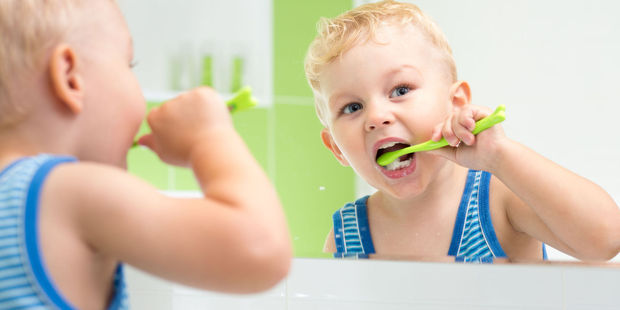 More than half of Kiwis surveyed are brushing their teeth incorrectly. Photo / 123RF