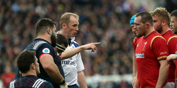 Referee Wayne Barnes talks to the Welsh side during yesterday's Six Nations clash. Photo / Getty