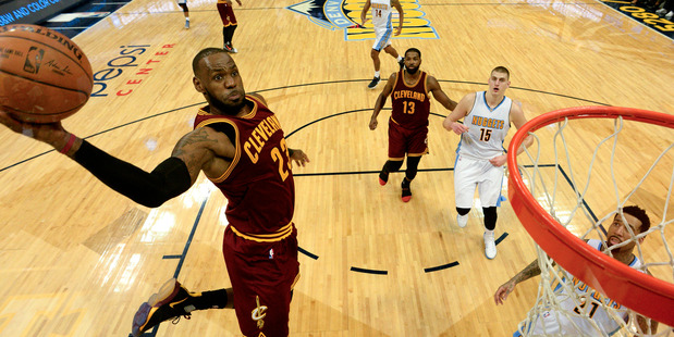 Cleveland forward LeBron James goes up for a big dunk against Denver Nuggets. Photo/Getty Images