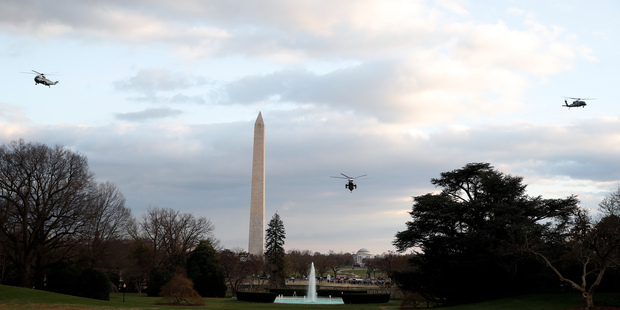 Marine One with President Donald Trump aboard, with two other similar helicopters, approaches for a landing on the South Lawn of the White House. Photo / AP
