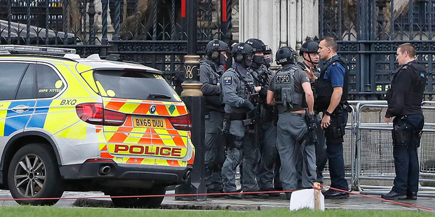 Armed police officers gather outside of the Houses of Parliament. Photo / AP
