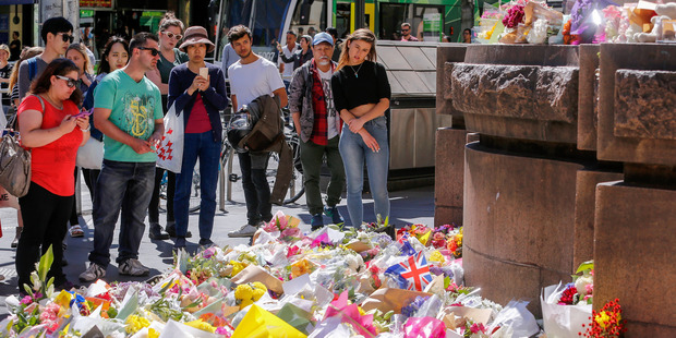 Mourners leave flowers and tributes to the victims of the Bourke St mall incident. Photo / Getty