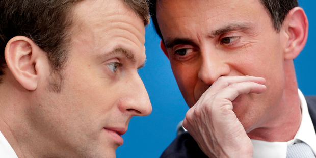 Former French Prime Minister Manuel Valls, right, speaks with former minister Emmanuel Macron in Paris. Photo / AP file