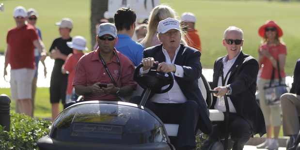 Donald Trump drives himself around the golf course to watch the final round of the Cadillac Championship golf tournament in Doral, Florida, earlier this month. Photo / AP