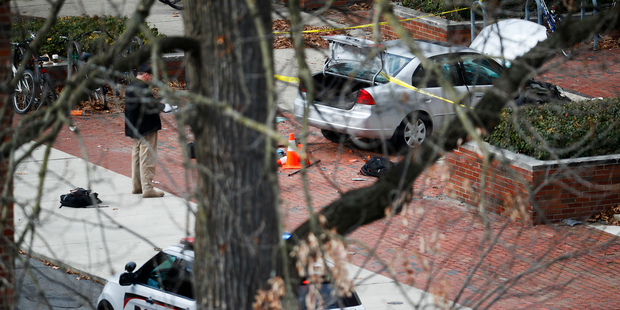 A car sits on the sidewalk as authorities respond to an attack on campus at Ohio State University, on November 28, 2016. Photo / AP