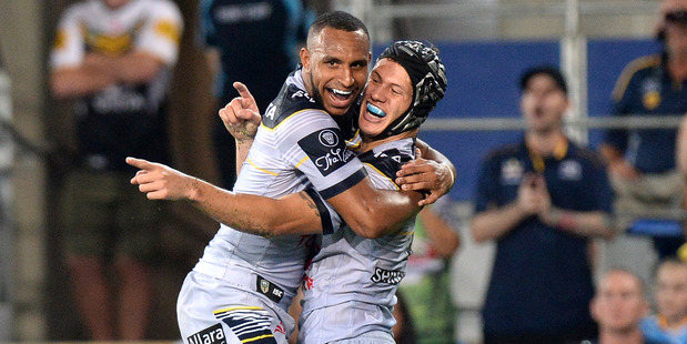Kalyn Ponga celebrates with Gideon Gela-Mosby after scoring a try against the Titans in the Gold Coast last night. Photo / Getty Images.