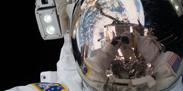 Floating in deep space, Jeff Williams takes the best selfie in history with an amazing reflection of planet Earth shining in his visor. CREDIT: NASA