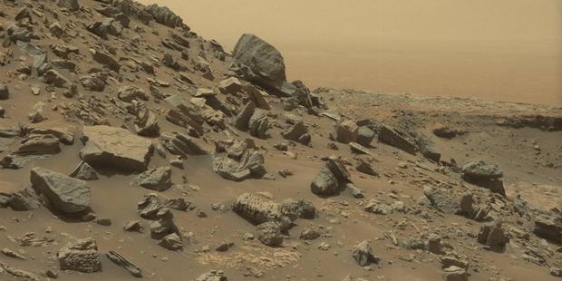 Nasa's Curiosity rover took this incredibly detailed image of a sloping hillside landscape on Mars last September, also revealing the planet's dusty haze. CREDIT: NASA
