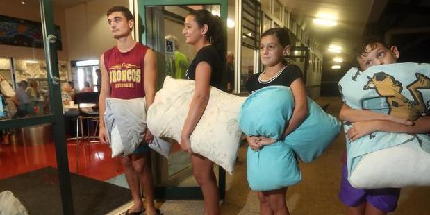 Giovanni Stewart, 17, Chevella Stewart, 12, Helena Stewart, 9, and Yuanito Stewart, 8, at the Kingscliff TAFE evacuation centre. Photo / Richard Gosling, News Corp Australia