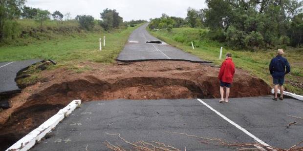 A bridge over Yatton Creek in north Queensland is partially washed away in the flooding rain that followed Cyclone Debbie. Photo / Supplied via News Corp