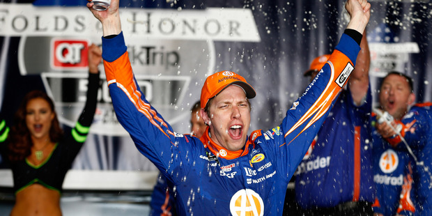 Brad Keselowski celebrates in Victory Lane after winning a NASCAR race. Photo / Getty Images