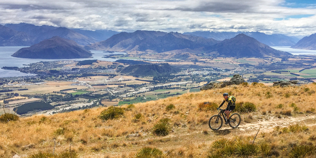 Michael Brown rides in the high country above Lakes Wanaka and Hawea during stage six. Photo / Greg Bowker
