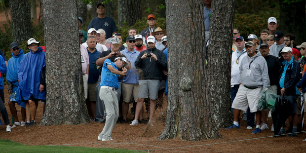Bubba Watson hits out of the pine straw on the second hole during a practice round for the Masters golf tournament Monday. Photo / AP.