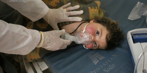 A Syrian doctor treating a child following a suspected chemical attack, at a makeshift hospital, in the town of Khan Sheikhoun. Photo / AP