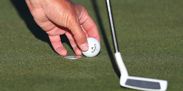 Phil Mickelson marks his ball during a practice round at the Masters golf tournament. Photo / AP