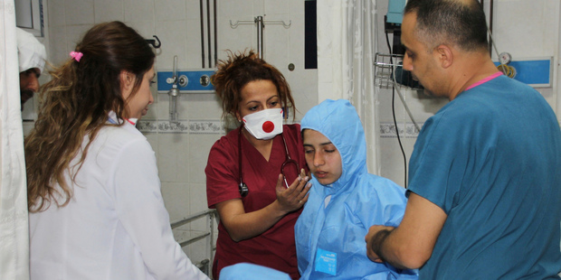 Turkish medics check a victim of alleged chemical weapons attacks in Syrian city of Idlib. Photo / AP