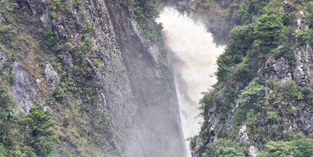 Water explodes through a gap in the Manawatu Gorge. Photo / Alecia Rousseau