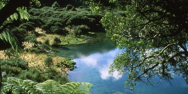 The Lake Waikaremoana Great Walk skirts a series of stunning, pristine bays fringed with brooding forest. Photo / Paul Rush