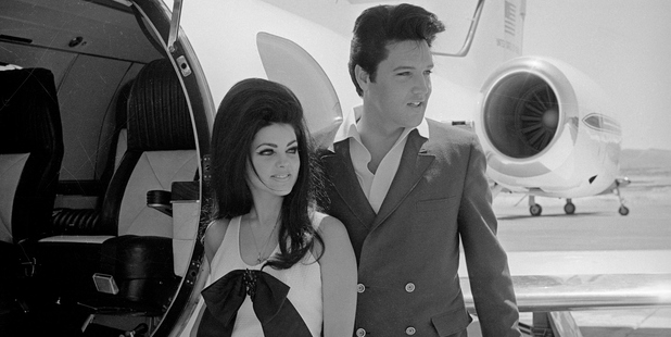 Newlyweds Elvis and Priscilla Presley, who met while Elvis was in the Army, prepare to board their private jet following their wedding. Photo / Getty