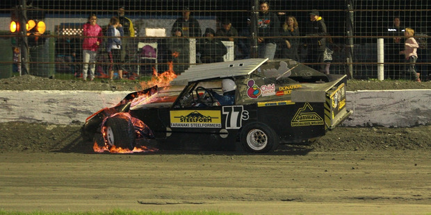 Blondie Chamberlain clips the wall with his car which promptly burst into flames during racing at Stratford Speedway on Saturday night. Photo / Andrew Hamblyn