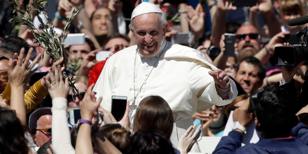 Pope Francis waves to the crowd after celebrating a Palm Sunday Mass in St. Peter's Square at the Vatican. Photo / AP