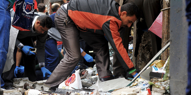 People search through debris after an explosion hit Saint Mark's Cathedral in the coastal city of Alexandria, the historic seat of Christendom in Egypt. Photo / AP