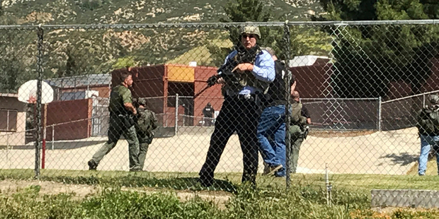 Emergency personnel respond to a shooting inside North Park School Elementary School. Photo / AP
