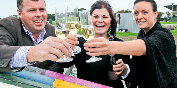 Hawke's Bay A & P Society president Richard Chambers, left, events manager Anna Hamilton and Mell Anderson toast the new format for this year's show in October. Photo/Duncan Brown
