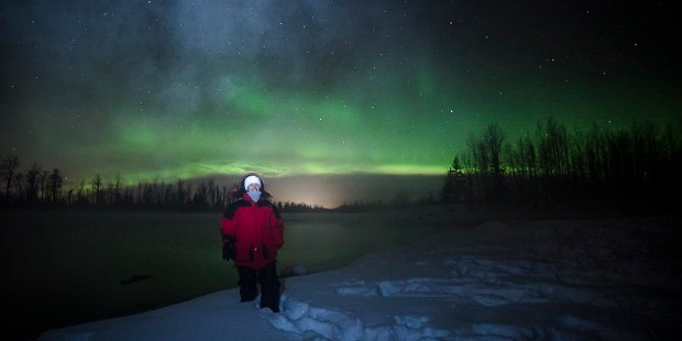 Anna Harrison in Alaska, with the Northern Lights above her. Photo / Jody Overstreet