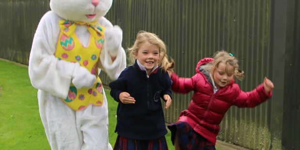 The Easter Bunny has a hopping competition with sisters Kelly (centre) and Katelyn Perrett.