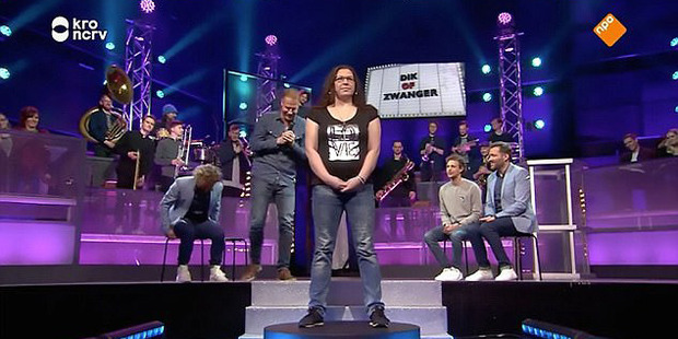A woman stands on a spinning podium while men guess if she's "fat or pregnant". Photo / Youtube