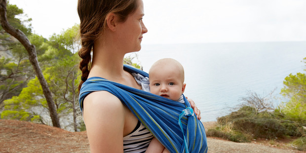 Carrying your baby while walking instead of using a pushchair gives you extra weight which is great for building strength. Photo / Getty Images.