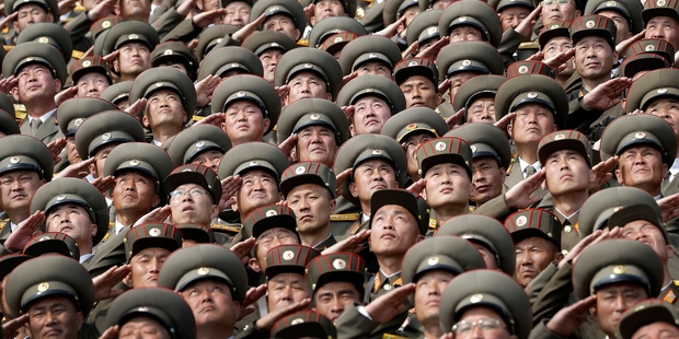 North Korean soldiers salute while the national anthem is played during a military parade on Saturday in Pyongyang. Photo / AP