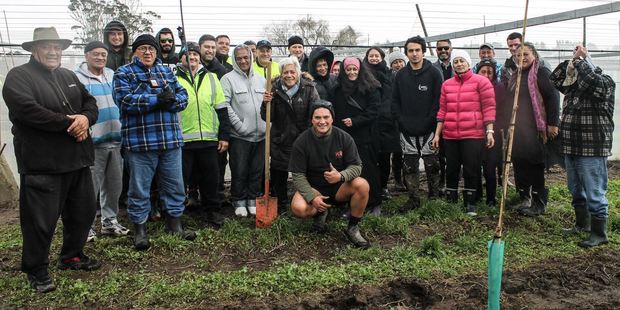 Residents of Matakana Island give the thumbs up after mucking in to help build Whai Orchard, part of a $30m investment to help build an enterprise for future Bay generations. Photo/supplied