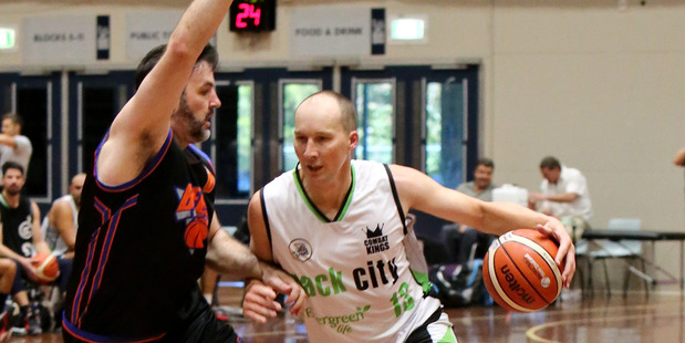 Tall Blacks legend Phill Jones drives on old rival Sam Mackinnon during their Anzac basketball clash at the World Masters Games 2017. Photo / Sylvia Wilkins