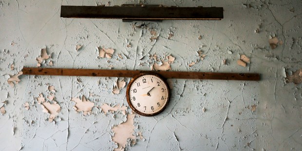 A broken clock hangs on a wall in a school in the deserted town of Pripyat. Photo / AP