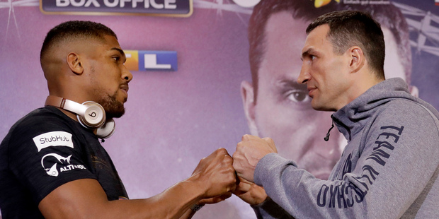 British boxer Anthony Joshua, left, and Ukrainian boxer Wladimir Klitschko tap fists as they finish posing head-to-head for the media. Photo / AP.