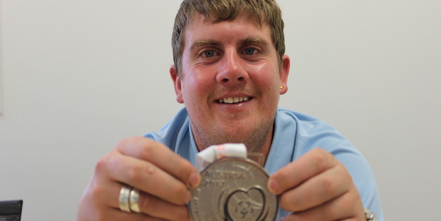 Jason Donovan with his silver medal from the Special Olympics World Winter Games.