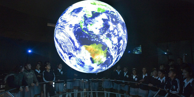 Schoolchildren watch a hologram that represents the earth during the opening session of the Climate Change Observatory called 'Mission earth' at the National History Museum in Mexico City. Photo / EPA