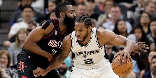 San Antonio Spurs forward Kawhi Leonard tries to post up Houston Rockets guard James Harden. Photo / AP