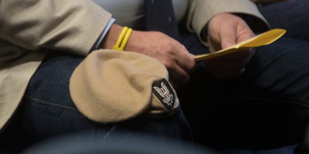 Robert Clark had the sand-coloured beret of the NZSAS on his knee.