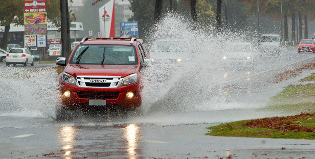 Surface flooding on Fenton St this afternoon. Photo/Ben Fraser