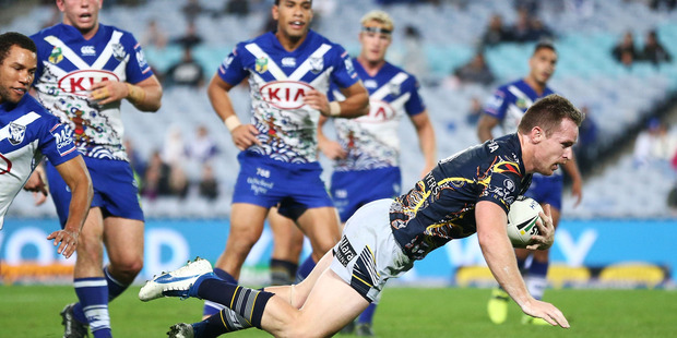 Michael Morgan of the Cowboys dives to score a try. Photo / Getty