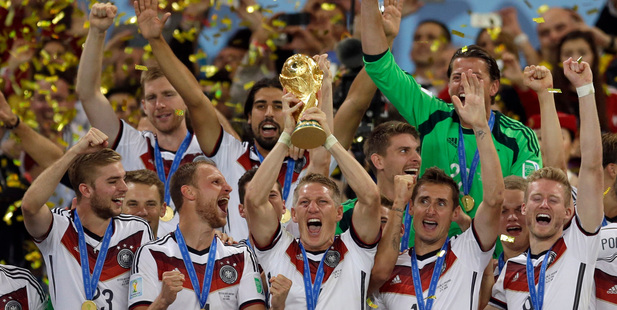 Germany's Bastian Schweinsteiger holds up the World Cup trophy. Photo / AP
