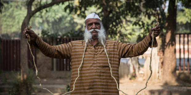 Ramesh Chand Kushawh, 78, holds his moustache in his hands. Photo / Australscope