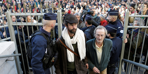 Cedric Herrou, center, a French activist farmer who faces up to five years in prison as he goes on trial accused of helping African migrants cross the border from Italy. Photo / AP