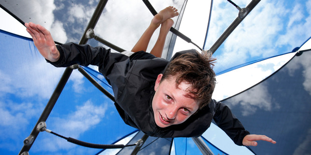 Tom Hughes, 13, from Maunu was hanging upside down in the shaded area of the Town Basin playground yesterday, staying cool but enjoying the summer weather in Whangarei. Photo / Michael Cunningham