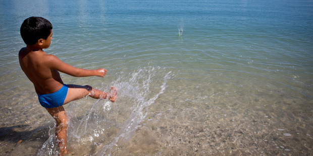 Enjoying the water at one of Waitawa Regional Park's coastal bays.