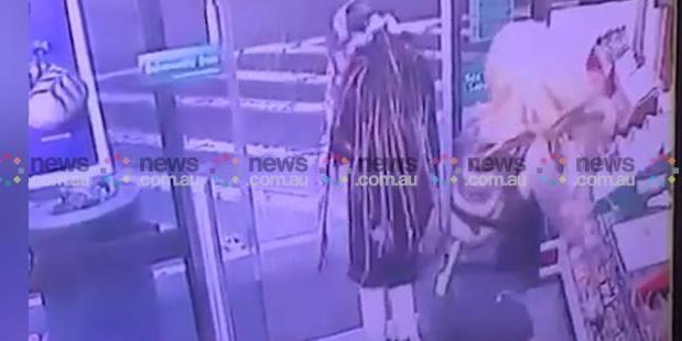 The woman steps over Ms Hacker with the axe and leaves the 7-Eleven premises while Ben Rimmer sits stunned in his own blood on the shop floor. Photo / News.com.au